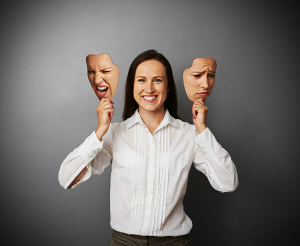 young beautiful woman hiding her good mood under masks