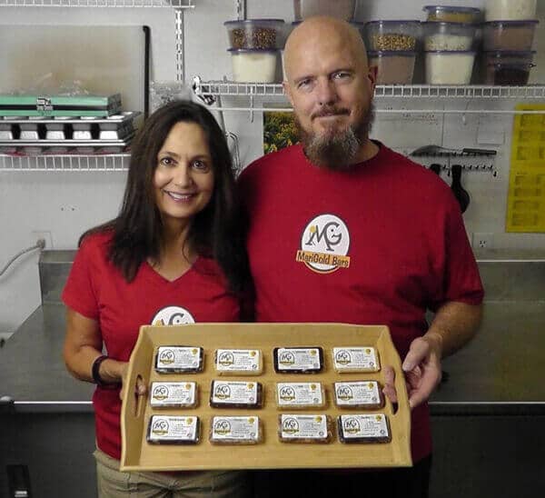 Mari Ann and Steve - Owners of MariGold Bars - Holding a dozen MariGold Protein Bars