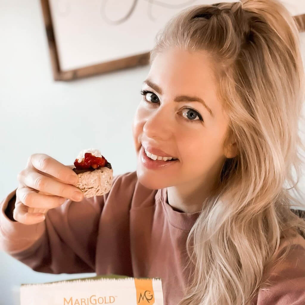 Hannah Scott holding Chocolate Protein Cheesecake Cups using MariGold Whey Isolate Protein Powder