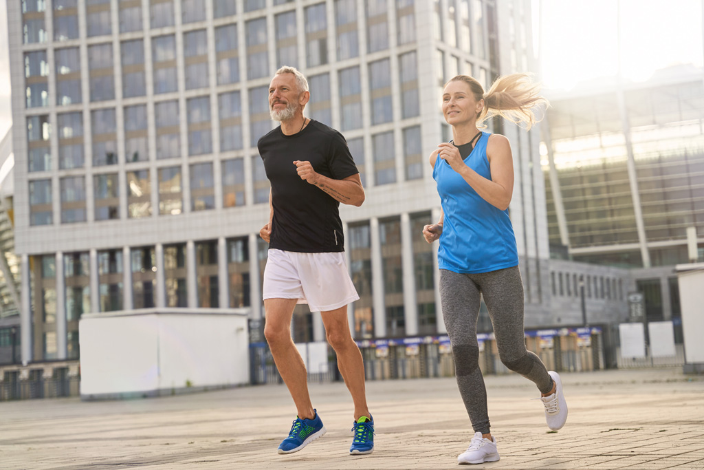 Middle Aged Man and Woman Jogging