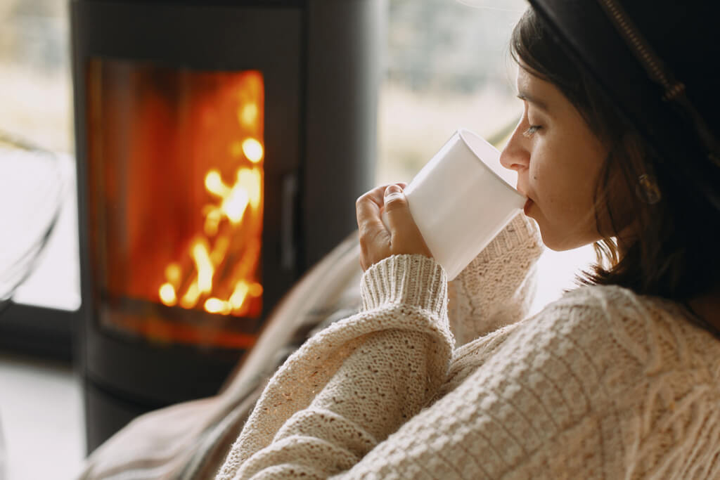 Non-Alkalized Cocoa vs. Alkalized - Woman Drinking Hot Cocoa by the Fire